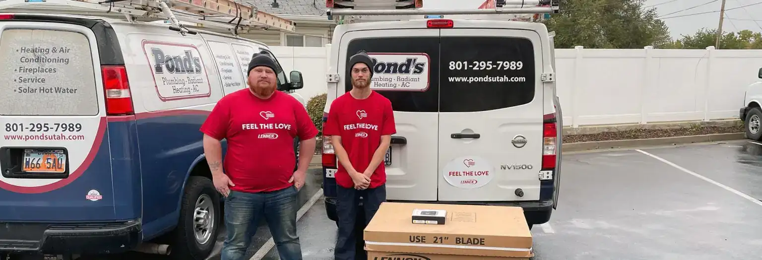 Two HVAC technicians from Pond's delivering a new HVAC system to a local hero for the Lennox Feel The Love initiative.